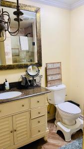 a bathroom with a sink and a toilet and a mirror at VIEW PRIVATE FEMALE Short-Long Term Day-Week-Month Un-Furnished Home-House-Estate Bedrooms-Studio-ADU-Guesthouse-Vacation Rental Encino Hills 405-101 xSepulveda in Encino