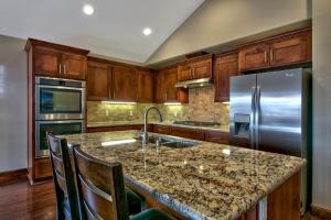 a kitchen with a granite counter top and stainless steel appliances at Conifer Chalet in South Lake Tahoe