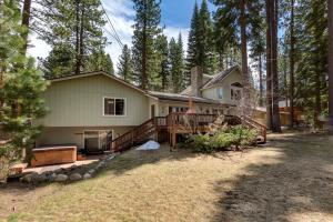 a house with a large deck in the woods at Sundown Lodge in Stateline