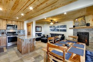 a kitchen and living room with a fireplace at Tall Pine Chalet in Stateline