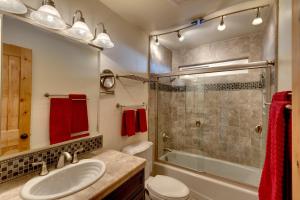 a bathroom with a sink and a shower and a toilet at Tall Pine Chalet in Stateline
