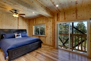 a bedroom with a bed and a ceiling fan at Tall Pine Chalet in Stateline