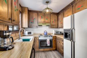 a kitchen with wooden cabinets and a white refrigerator at Snowflake Chalet in Stateline
