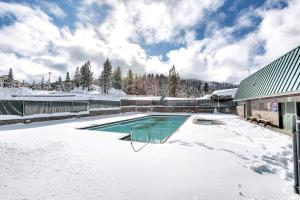 a swimming pool covered in snow next to a house at Snowflake Chalet in Stateline