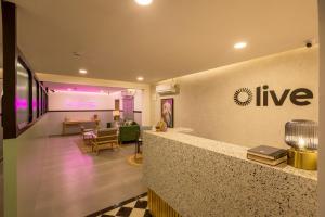 a lobby with a live sign on the wall at Olive Indiranagar 100ft Road - by Embassy Group in Bangalore
