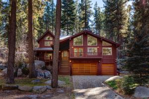 a house in the woods with a garage at Silver Rock Lodge in Zephyr Cove