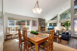 a dining room and living room with a table and chairs at Spacious Riverfront in South Lake Tahoe