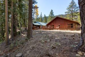 a red barn in the middle of a forest at Spacious Riverfront in South Lake Tahoe