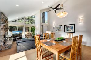 a dining room and living room with a table and chairs at Spacious Riverfront in South Lake Tahoe