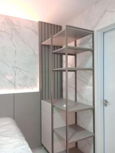 a bedroom with a book shelf next to a bed at Laguna Beach House in Cabedelo