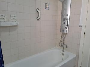 a bathroom with a bath tub with a shower at Bienvenido a tu habitacion in Málaga