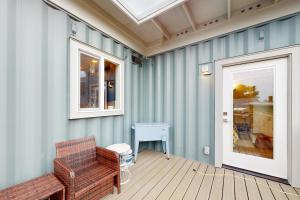 a room with two chairs and a door and a table at Shipwreck in Pacific City