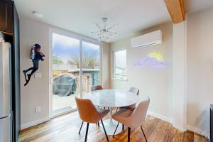 a dining room with a glass table and chairs at Shipwreck in Pacific City