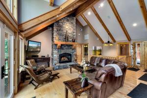 a living room with leather furniture and a stone fireplace at Forest View Lodge in South Lake Tahoe