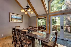 a dining room with a wooden table and chairs at Forest View Lodge in South Lake Tahoe