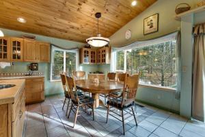 a dining room with a table and chairs in a kitchen at Sequoia Chalet in Stateline