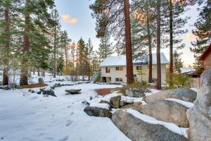 a house in the woods with snow and trees at Sequoia Chalet in Stateline