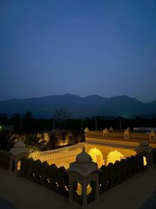 a view of a building with lights at night at Farm Aavjo in Pushkar