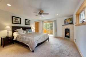 a bedroom with a large bed and a fireplace at Lodgepole Pine Chalet in South Lake Tahoe