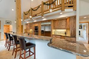 a large kitchen with a large island with bar stools at Lodgepole Pine Chalet in South Lake Tahoe