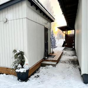 a porch of a house with snow on it at Guest house - Northern tealight in Rovaniemi