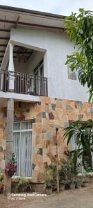 a building with a balcony on the side of it at Gautham Villa in Mirissa