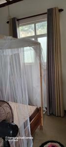 a bedroom with a bed and a window at Gautham Villa in Mirissa +7 photos