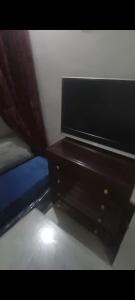 a wooden dresser in a bedroom with a curtain at Rabat center studio in Rabat