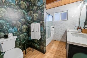 a bathroom with a shower and a toilet and a sink at Ski View Chalet - Prepare to be awestruck with the breathtaking and massive mountain views! in Big Bear Lake +22 photos