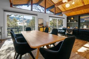 a living room with a wooden table and chairs at Ski View Chalet - Prepare to be awestruck with the breathtaking and massive mountain views! in Big Bear Lake