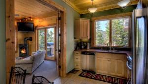 a kitchen with a stove and a couch in a cabin at Rock Haven in Stateline