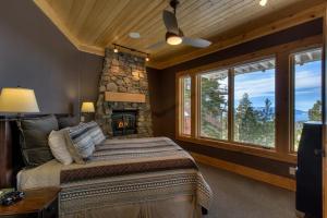 a bedroom with a large bed and a stone fireplace at Rock Haven in Stateline