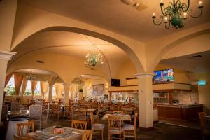 a restaurant with tables and chairs and a chandelier at Holiday Inn La Piedad by IHG in La Piedad Cavadas