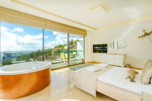a bedroom with a tub and a bed with a view at infinity wild in Kalkan