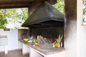 an outdoor kitchen with a large black stove at Acogedor alojamiento rural ideal para grupos in Agres