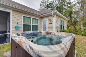 a hot tub in front of a house at Rincon Home with Game Room, 18 Mi to Savannah! in Rincon