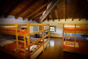 a room with three bunk beds in a house at Riera d'Agres, relax, rural, grupos in Agres