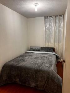 1 dormitorio con cama y ventana en Apartamento completo en Callao, en Lima