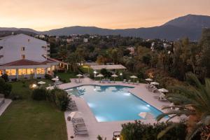 an overhead view of a swimming pool with a resort at Livadi Nafsika Hotel in Dassia