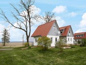 a white house with a red roof at Cottage on the Kummerower See, Kummerow in Kummerow