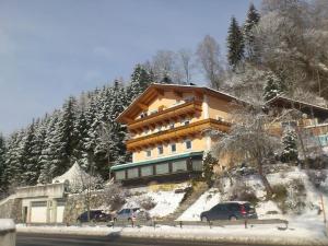 a building on the side of a snow covered mountain at Appartement in Uttendorf