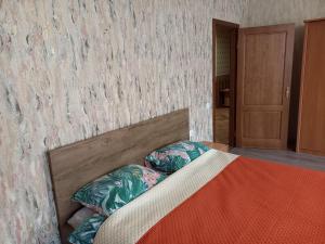 a bed with two pillows on it in a room at Daugavpils City Centеr Apartment in Daugavpils