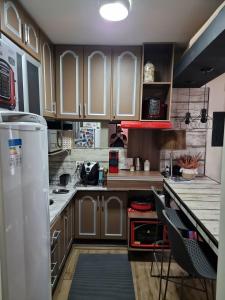 uma cozinha com armários de madeira e uma bancada em Apartamento/ flat em São Vicente em São Vicente