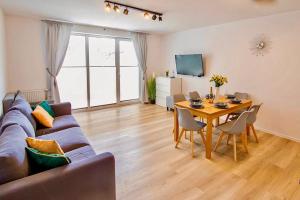 a living room with a couch and a table at Apartament "Biała Perła" in Dziwnówek