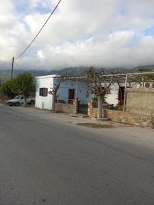 a white house on the side of a street at house FYNTIKAKH - SKALA in Anopoli Sfakion