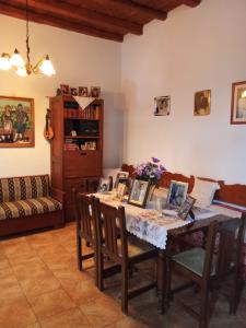 a living room with a table with chairs and a couch at house FYNTIKAKH - SKALA in Anopoli Sfakion