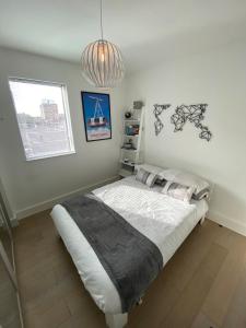 a bedroom with a bed and a pendant light at Tasteful 2BD Flat wOpen Plan Living - Blackheath! in London