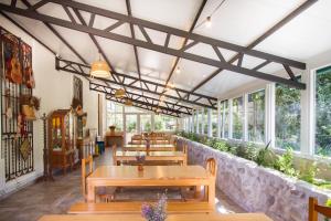a restaurant with wooden tables and benches and windows at Acogedor alojamiento rural ideal para grupos in Agres