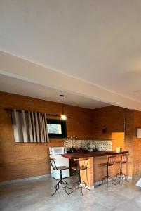 a kitchen with a table and chairs in a room at Pousada Fazenda Vitoria in São João Batista do Glória