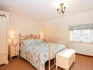 a bedroom with a bed and a window at Kath's Cottage in Heacham